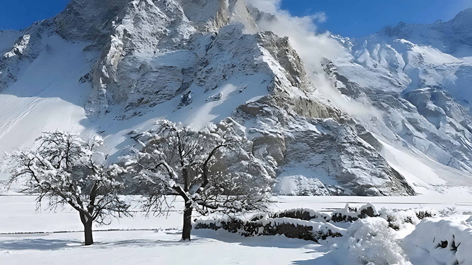 Majestic mountain peaks under a clear blue sky in northern Pakistan.